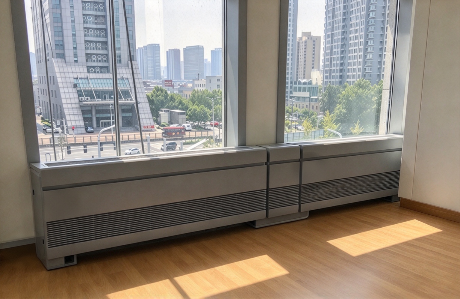 Surroundline convectors installed beneath apartment windows overlooking the city